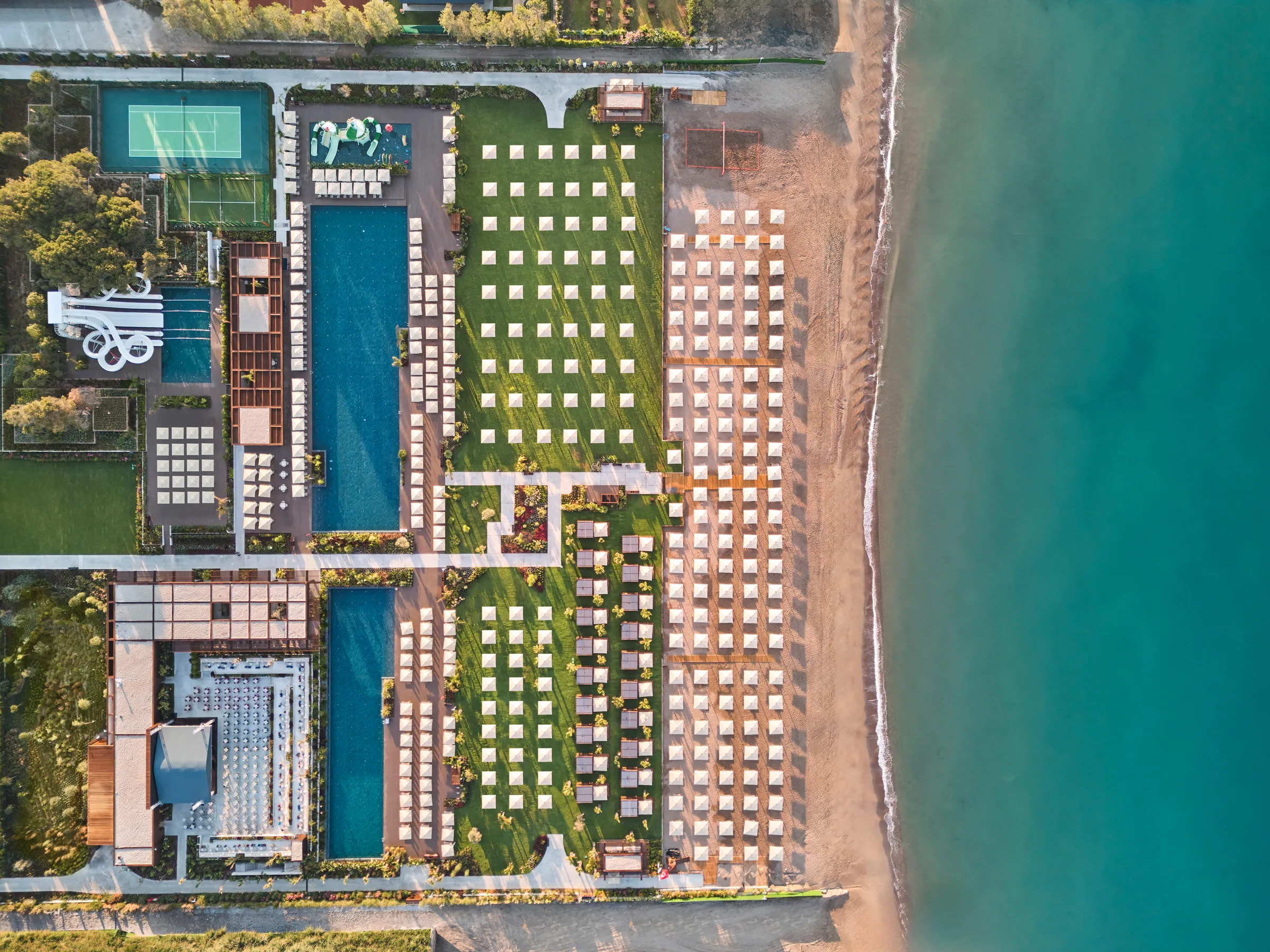 Top-down view of pools, gardens and beach at Voyage Belek